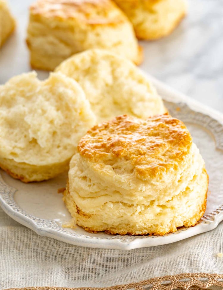 a couple buttermilk biscuits on a plate.