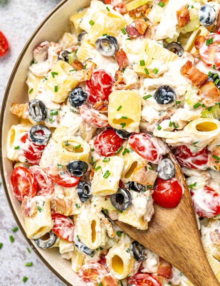 chicken ranch pasta salad in a beige bowl.