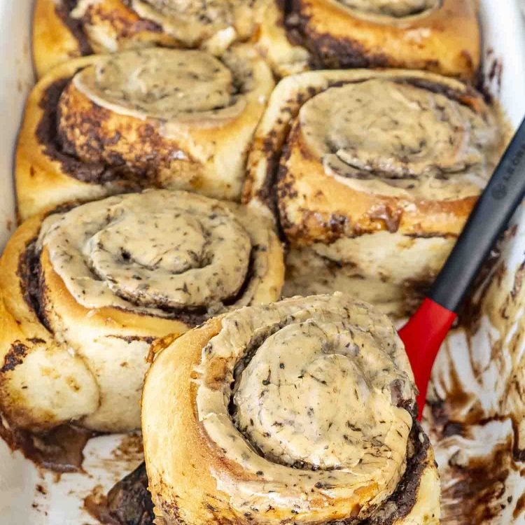 freshly made chocolate espresso rolls in a baking dish with espresso icing.