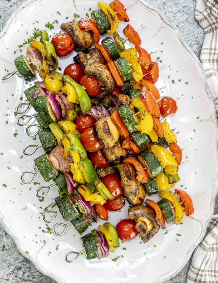grilled veggie skewers fresh off the grill on a platter.