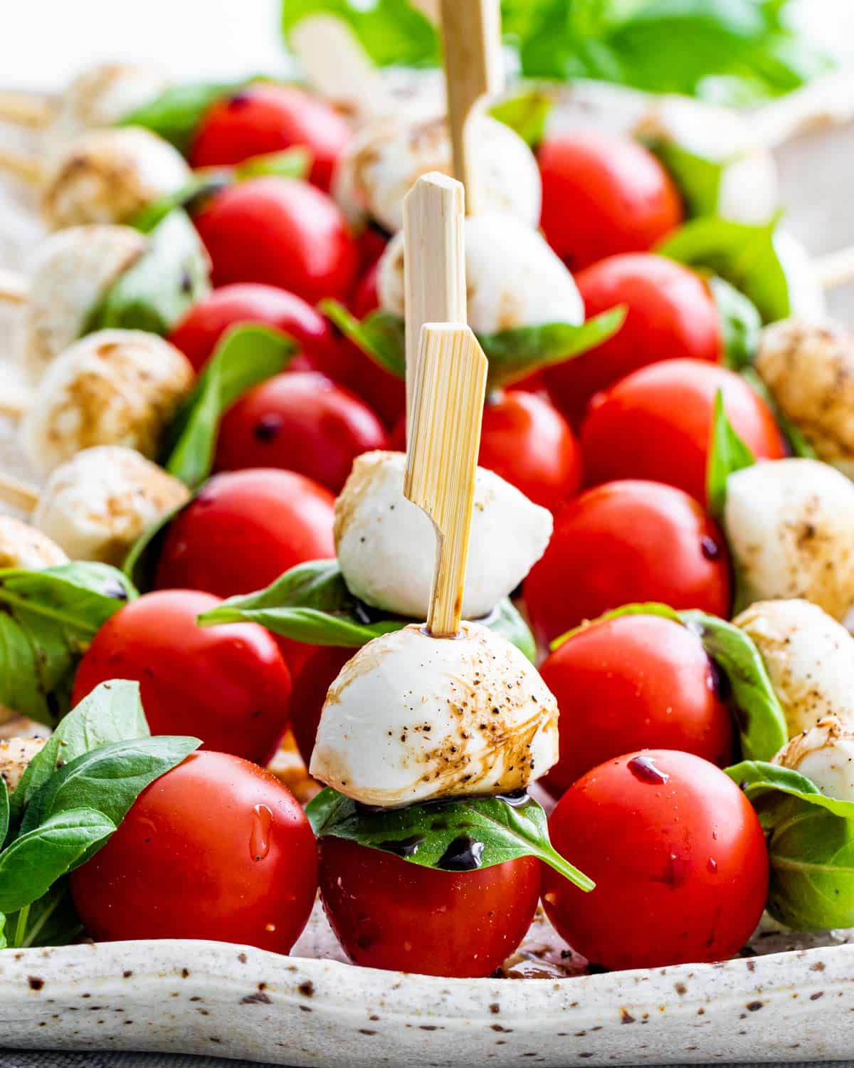 caprese salad bites on a serving platter