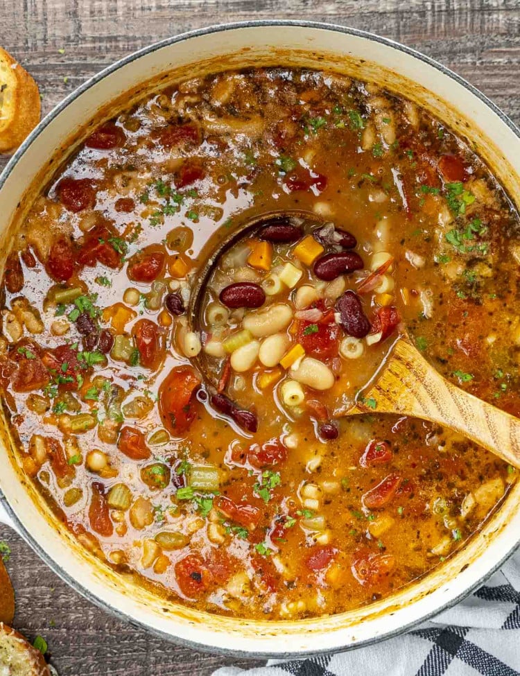Top-down view of a hearty pot of pasta e fagioli soup, filled with beans, vegetables, pasta, and rich broth.