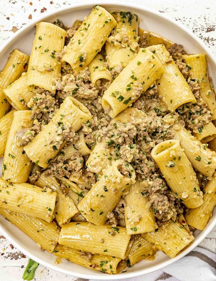 freshly made pesto beef pasta in a large white bowl.