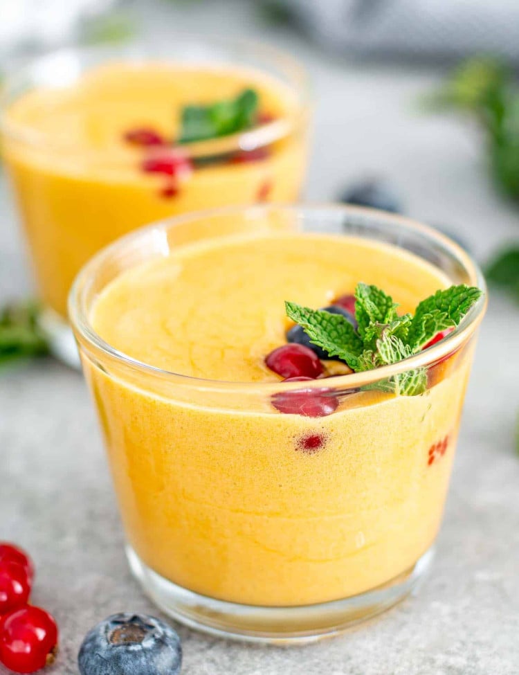 zabaglione in 2 glasses topped with berries.